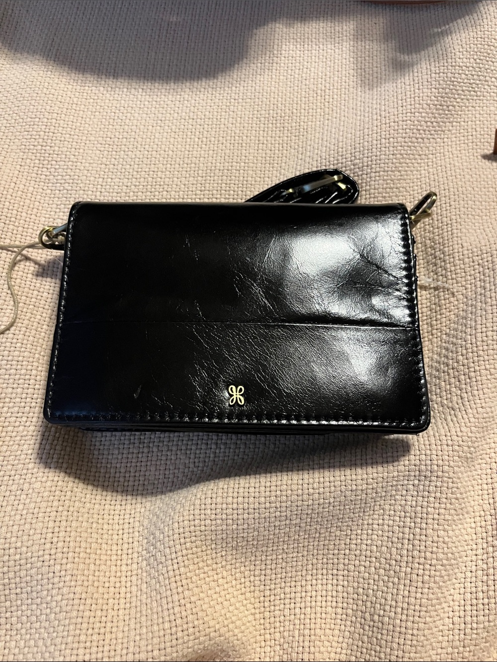 HOBO Black Leather Crossbody Wallet with Gold Logo Accent
